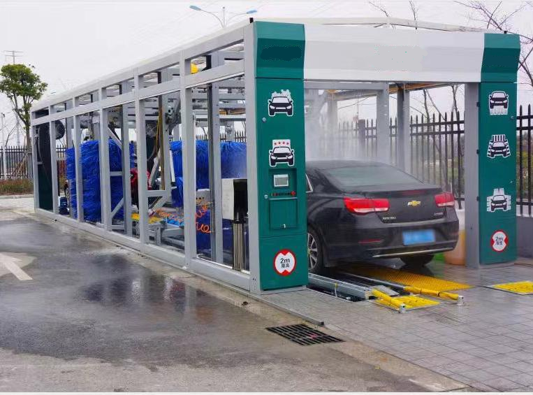Commercial tunnel car wash system with multiple washing stations, modern design, white and blue equipment